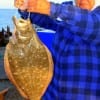 Gilchrist angler Bobbie West hefts her husband's 24 inch flounder caught on Berkley Gulp