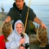 Pete Sullivan of Spring TX kudos Tabatha Earlywine with her very first flounder catches she took on shrimp
