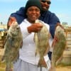 Rhonda and Mark Lewis of Houston heft Rhonda's three keeper eater drum caught on shrimp