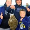 The Mathis Family gives a BIG thumbs up for their son Trontin's very first flounder catch he took on Berkley Gulp