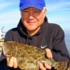 Kil Yoo of Dallas TX hefts this nice flounder caught on Berkley Gulp