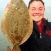 College Station TX angler Kirby Ratcliff is all smiles after she nailed this 16 inch flounder on squid