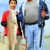Grandpa and Grandson Carlos and Jacob Duran of Houston caught and tagged this 32 inch Bull red they caught on cut bait