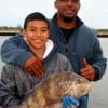 Father and Son- DeAndre Kanney of Tomball TX hefts this nice sheepshead he caught on shrimp