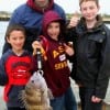 Ten year old Seth Deaton of Austin and family shows off his nice sheepshead caught on shrimp before releasing it