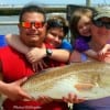 The Adams Family of Mont Belview TX applaud Mom's HUGE catch and tag of her 40 inch Bull Red she caught on shrimp