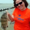 Brittany Zavala of Beaumont hefts this nice keeper drum caught on shrimp