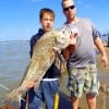 Father and Son anglers Andrew and Hunter Bertrand of Tomball TX show off the Huge drum that Hunter caught and released while fishing shad
