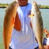 Leonard Fields of Houston hefts this nice red and speck caught on finger mullet and live shrimp