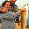 Ricky and Brittany Newton of Splendora TX show off this 32inch bull red she caught and released on finger mullet