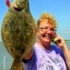 Tami Patterson of Devers TX informing a friend about her flounder catch she took on shrimp