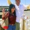 The Beauty and the Beast- Moi Ngyuen of Kansas helps Henri Fontenot show off his nice trout he took on a T-28 MirrOlure