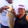 Fishin buds- Demitra Fisher and Ester Ochoa of Houston shows off this nice 23inch slot red Demitra caught on shrimp