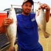 Houston angler Robert Aquirrie displays 2 of his 6 trout he caught on soft and hard plastics