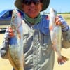 Houston angler Sonny Lin hefts these two nice specks caught on red and white MirrOlures
