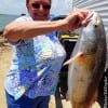 Janis Jones of Seabrook TX hefts this 25inch slot red caught on a finger mullet