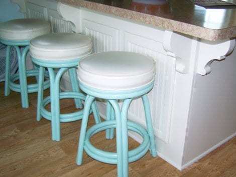 The swivel rattan stools are vintage and she painted them.