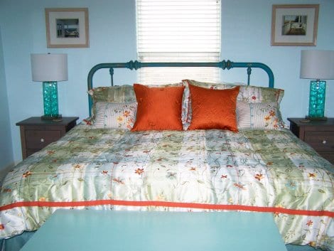 The brass bed in the master is also painted a deep shade of turquoise.  
