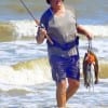 Chuck Meyers of Gilchrist exits the surf with a good stringer of specks he took on T-28 MirrOlures