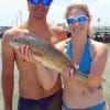 Antoine and Mellissa Hythier of Houston show off Mellissa's 23inch slot red she caught on a freelined finger mullet
