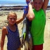 Cousins Kelsie and Colton of Groveton TX Shank spent time with grandma wading the surf with silver spoons to catch these nice specks and Smacks