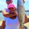 Fishing mates Joel and Angela Munoz of Alvin TX heft Angela's 24 inch slot red she caught on live shrimp
