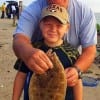 Grandpa McCown with Grandson Chance who just caught this nice flounder on a finger mullet