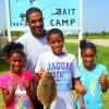 Dad and Kids- Trumaine Jr, shows off his nice flounder with Dad, Trumaine Sr, and Sisters, Jamaren, Jadaya giving thumbs up for his finger mullet catch