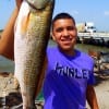 Julio Rozano of Houston hefts this 24 inch slot red caught on a finger mullet