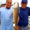 Father and Son- Jonry and Rolly Edralin of Sugar Land TX teamed up to catch this nice 21inch slot red on live shrimp