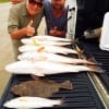 Fishin buds Phil Miller and Jody Bearlin of Beaumont TX teamed up to tailgate this mess of redfish, flounder, and sandies