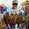 Gummi Lam of Houston fished live finger mullet to tether up these nice flounder