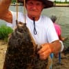 Hughey Singleton of Winnie TX hefts this 5 flounder limit caught on finger mullet