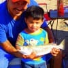 In awe of hs very first fish 2yr old Joseph Punteria of Houston celebrates with Daddy Isalas