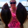 Katie Gobert of Beaumont hefts these two 19inch flounder caught on finger mullet