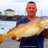 Making his ONE MORE cast before leaving- Chris Loyd of Rusk TX nabbed this HUGE 40plus inch tagger bull red from the surf on cut croaker