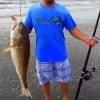 Roy Flores of San Antonio hefts this 38inch tagger bull red caught on cut croaker