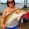 Samantha Dickens of Channelview TX hefts this nice red caught on a finger mullet