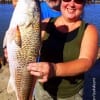 David and Carol Wille hold up Carol's first redfish she ever caught- a 30inch tagger bull red caught on shrimp