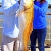 Fishin buds Jonry Edralin and Belinda Chapa of Conroe TX teamed up to catch this HUGE 35inch tagger bull red on live shrimp