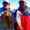 Fishin pals Charles Davis and Wallace Moore of Houston took this red and flounder on live shrimp