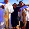 Mat and Francisco Martinez with Frank Garza show off their 32 and 42inch tagger bull red they caught on cut mullet