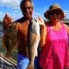 Sherrie and Stan Peeples of Kauii Hawaii nabbed this nice slot red and keeper flounder on finger mullet