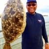 Claude Cummngs of Houston hefts this nice flounder caught on live shrimp