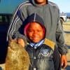 Father and son- Nathan and Ethan Howard of Houston teamed up to catch this nice flounder on a finger mullet