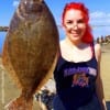 Houston anglerette Angela Goodman hefts this 20inch doormat flounder caught on a finger mullet