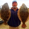 Briarcliff TX angler Stuart Yates hefts these two nice flounder that hit a Berkley Gulp