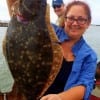 Cindy Wilson of Kemah TX hefts this nice 19inch flounder caught on Berkley Gulp