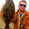 Ken Allen of Winnie TX hefts this nice 18inch flounder caught on Berkley Gulp