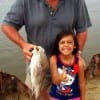 Grandpa and grandkid Lynn and little Zoey McKay of the Woodlands TX show off gramp with his drum caught on shrimp